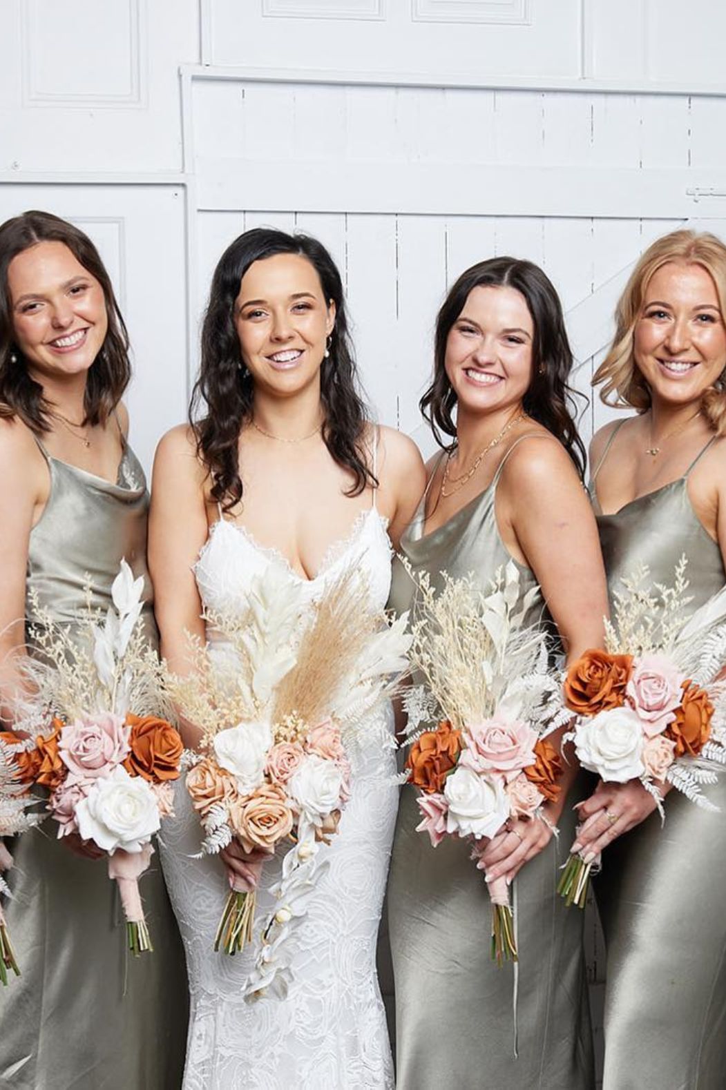 Dried bridesmaid bouquets in soft pink, ivory and rust tones